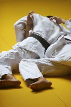 Judo fighters wrestling for supremacy - some grain visible