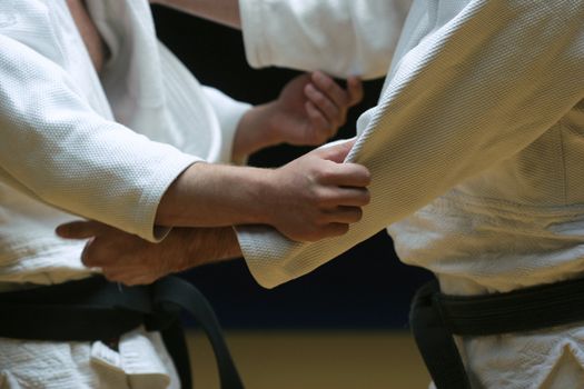 Judo fighters sparring off in a battle of body and mind - selective focus and visible grain
