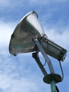 Metallic spotlight close up with sky background