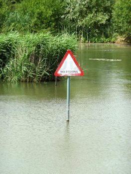 A no fishing sign in the middle of a lake.