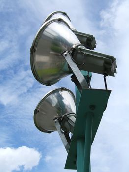 Metallic spotlight close up with sky background