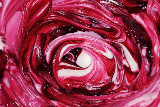 Thick icing being mixed with a swirl texture