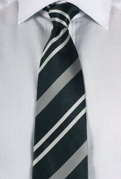 Business man wearing a new white shirt and a tradional neck tie