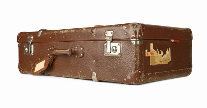 Old and worn retro suitcase isolated on white background - focus on corner nearest to camera