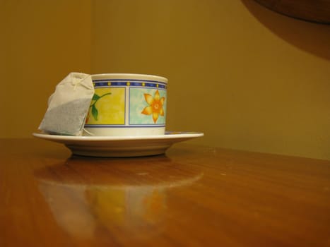 a tea bag beside a cup