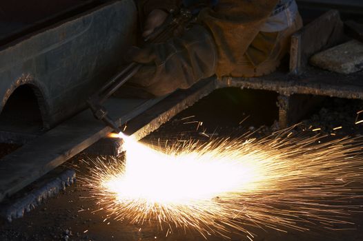 a shipyard steel worker burning steel