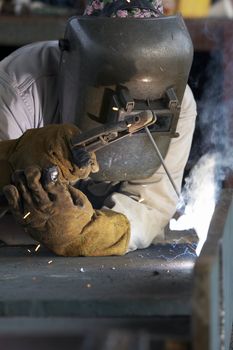 a welder working at shipyard during day shift