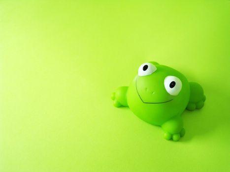 a frog toy on a green background