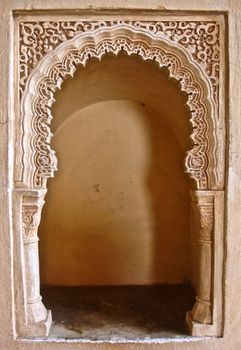 a miniature gateway carved into a wall