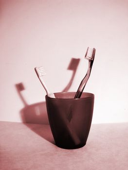 a communication for father's and son' toothbrush in a glass