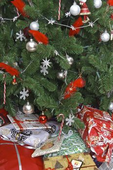 Presents of all sizes under a beautiful christmas tree