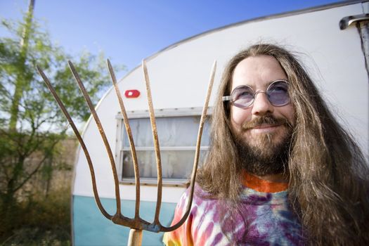 Friendly Hippie with Long Hair and a Pitchfork