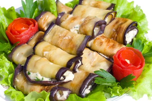 close-up many stuffed eggplant with cheese and garlic on plate