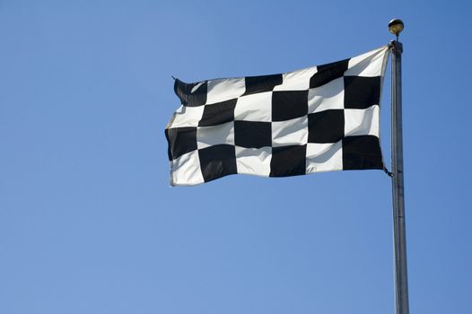 A finish line flag on a pole at a raceway.