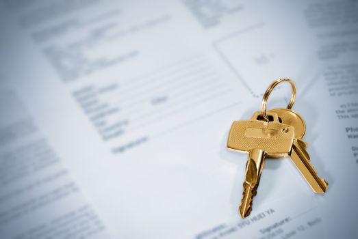 Keys in golden color on blue paper.