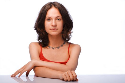 Serious young woman posing on white background