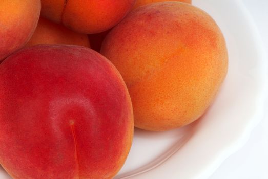 Fresh peaches on a dessert plate. A close up.