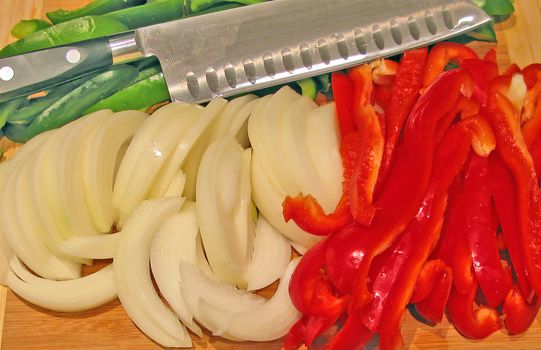 Sliced Vegetables with a Knife on a Cutting Board