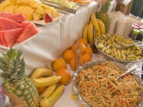Buffet Table with fruit and noodle, pasta salad.
