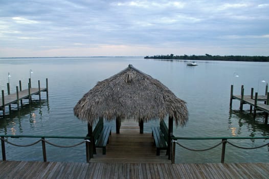 A view of a lake, with docks and hut.