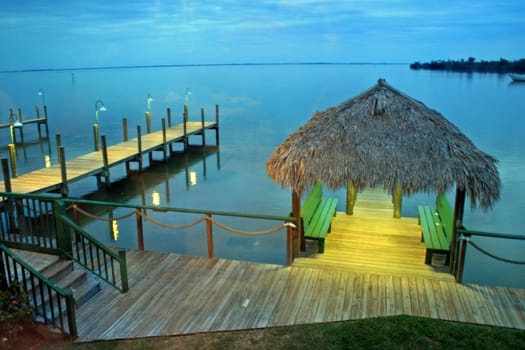 A view of a lake, with docks and hut.