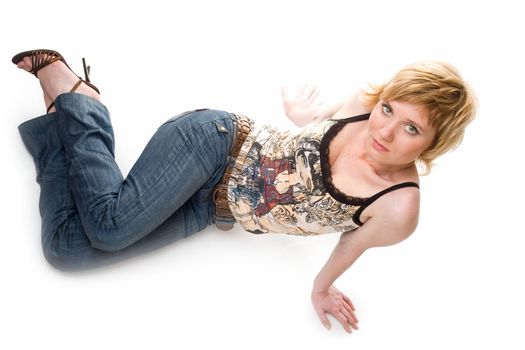 Sexy young woman lays on a white background.