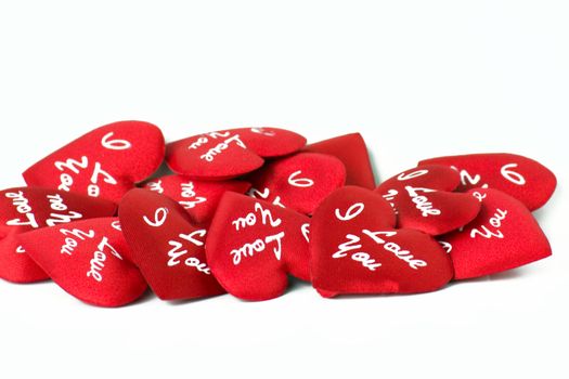 A lot of red hearts with words on a white background.