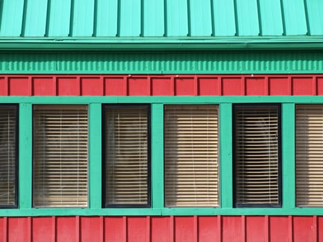 A red building with green trimmed windows, great bold box shapes for text.