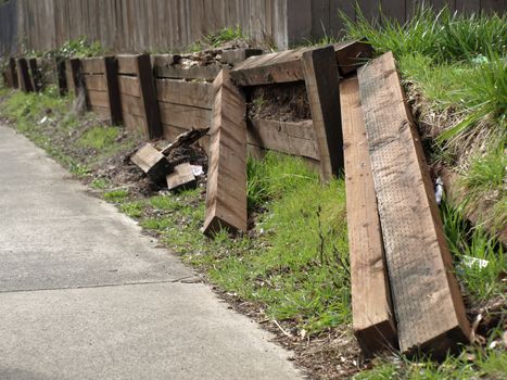 A retaining wall in a vandalized state in need of repair.