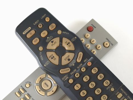 Two remote controls for VCR and CD player isolated over white.