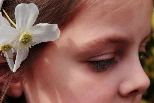 portrait of a young girl on her first communion in ireland with a flower in her hair