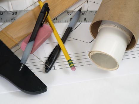 Plans in tubes and work tools on an engineer's desk.