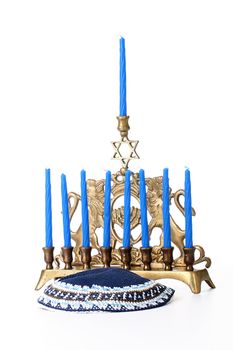 Candlestick for nine candles with candles and skullcap in Judaic religion.
