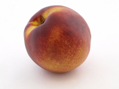 a single juicy peach isolated against a white background