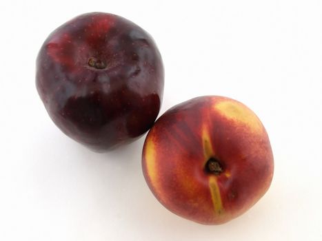 Crisp red apple and ripe juicy peach isolated on a white background