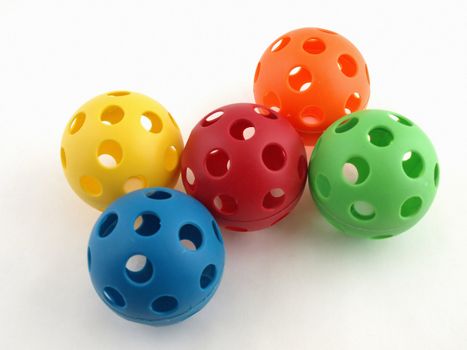 Colorful plastic balls with holes isolated on a white background.