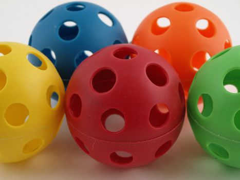 Colorful plastic balls with holes isolated on a white background.