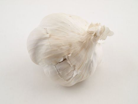 A whole clove of garlic isolated on a white background