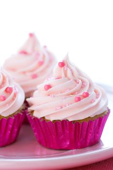 Cupcakes decorated with pale pink frosting