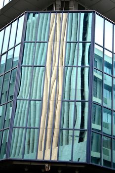 Reflection in the large glass panels of a modern building