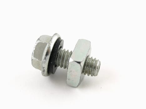 A nut and bolt screwed together and isolated on a white background