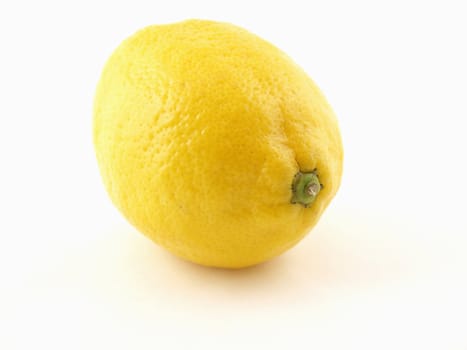 A solitary yellow lemon isolated on a white background.