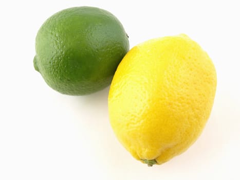 A green lime and a yellow lemon isolated on a white background