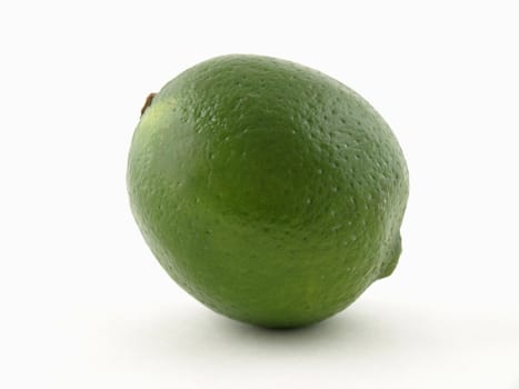 A solitary green lime isolated on a white background.