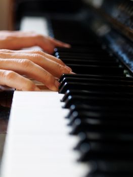 Pianist playing with selective focus on fingers