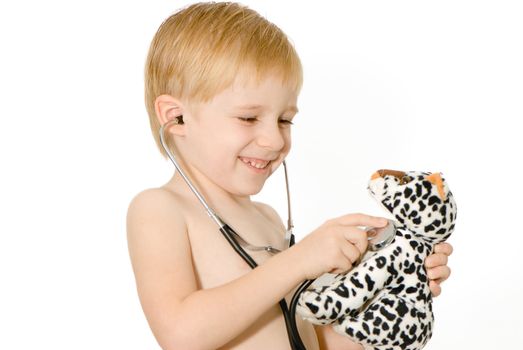 Portrait of the cheerful boy with stethoscope. Emotions