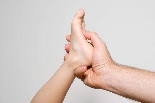 Children's foot in a man's hand. Massage