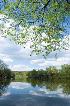 Clouds reflected in a pond at spring