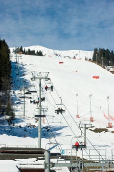 Chairlift beside a piste Meribel ski resort, French Alps