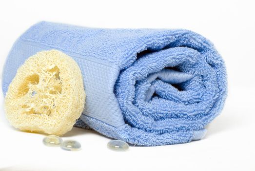 Towel with a sponge on a light background
